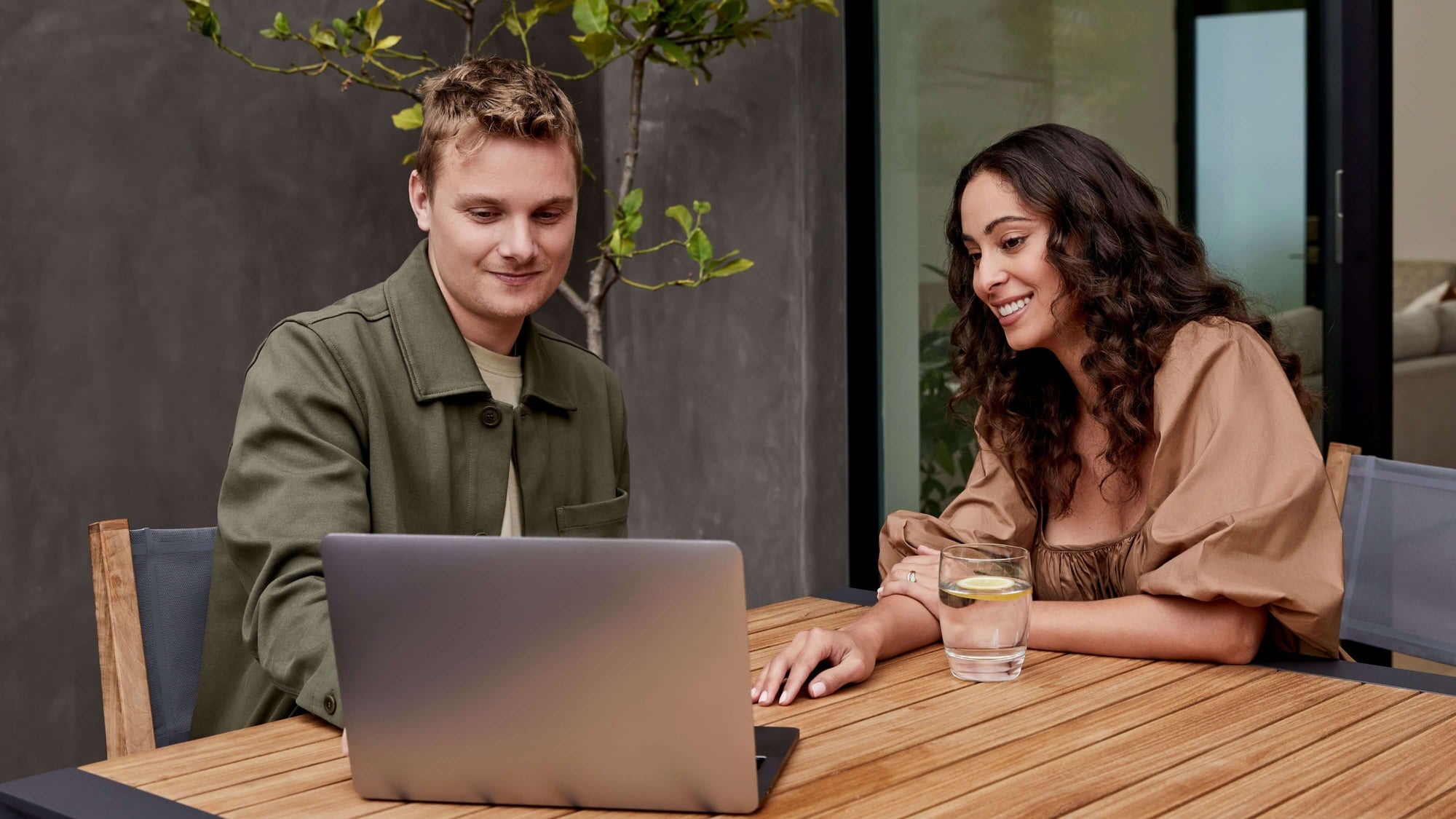 Woman using a laptop at an outdoor table