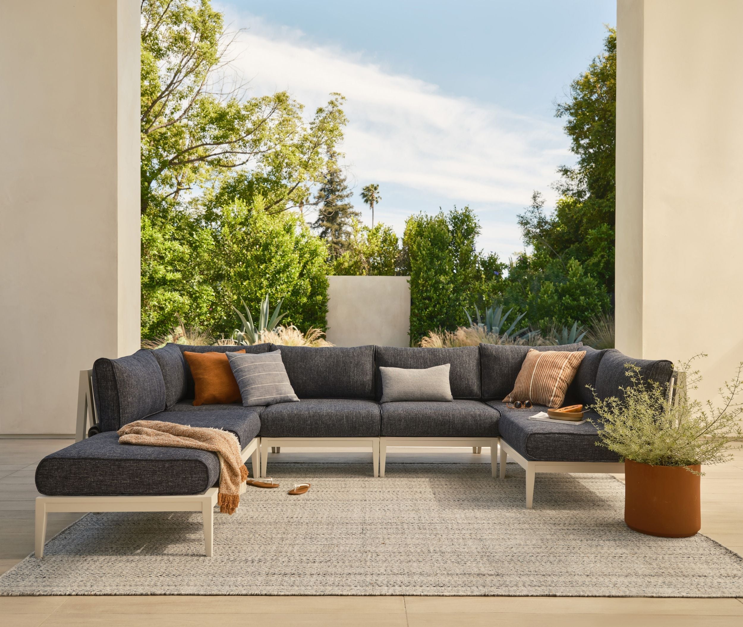 Modular outdoor sofa arranged in a covered patio